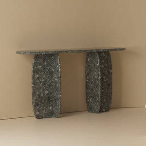 Catus Console Table - Outdoor in dark speckled stone against a beige wall