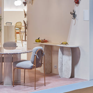 Catus Console Table - Outdoor in pale marble in a styled room with a striped chair