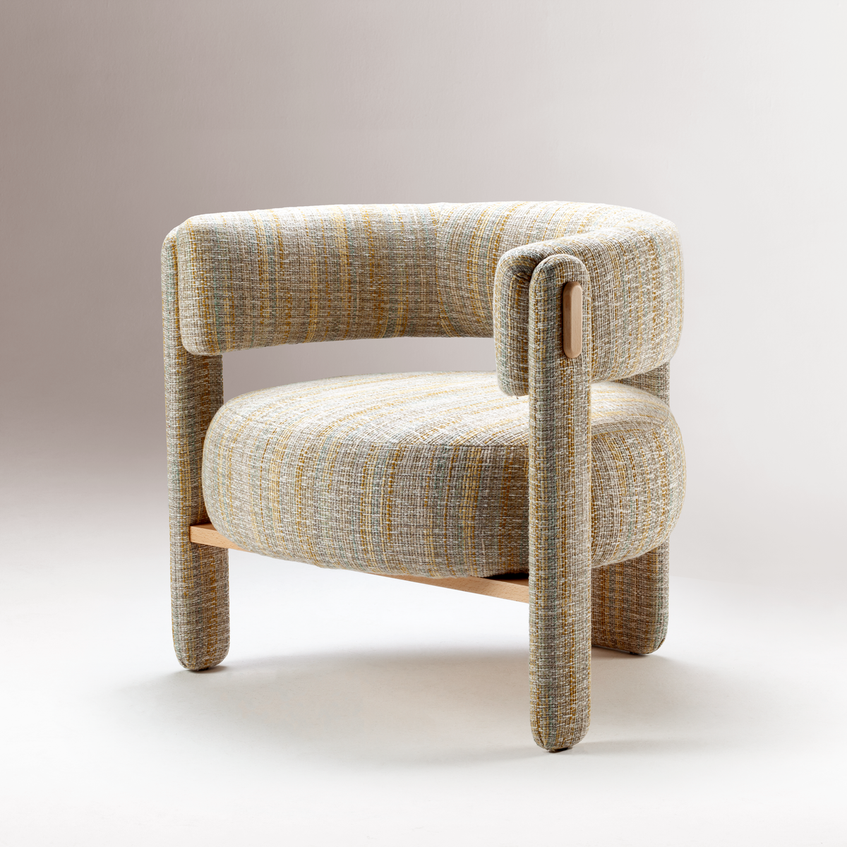Choux Armchair in striped weave on a soft grey gradient backdrop