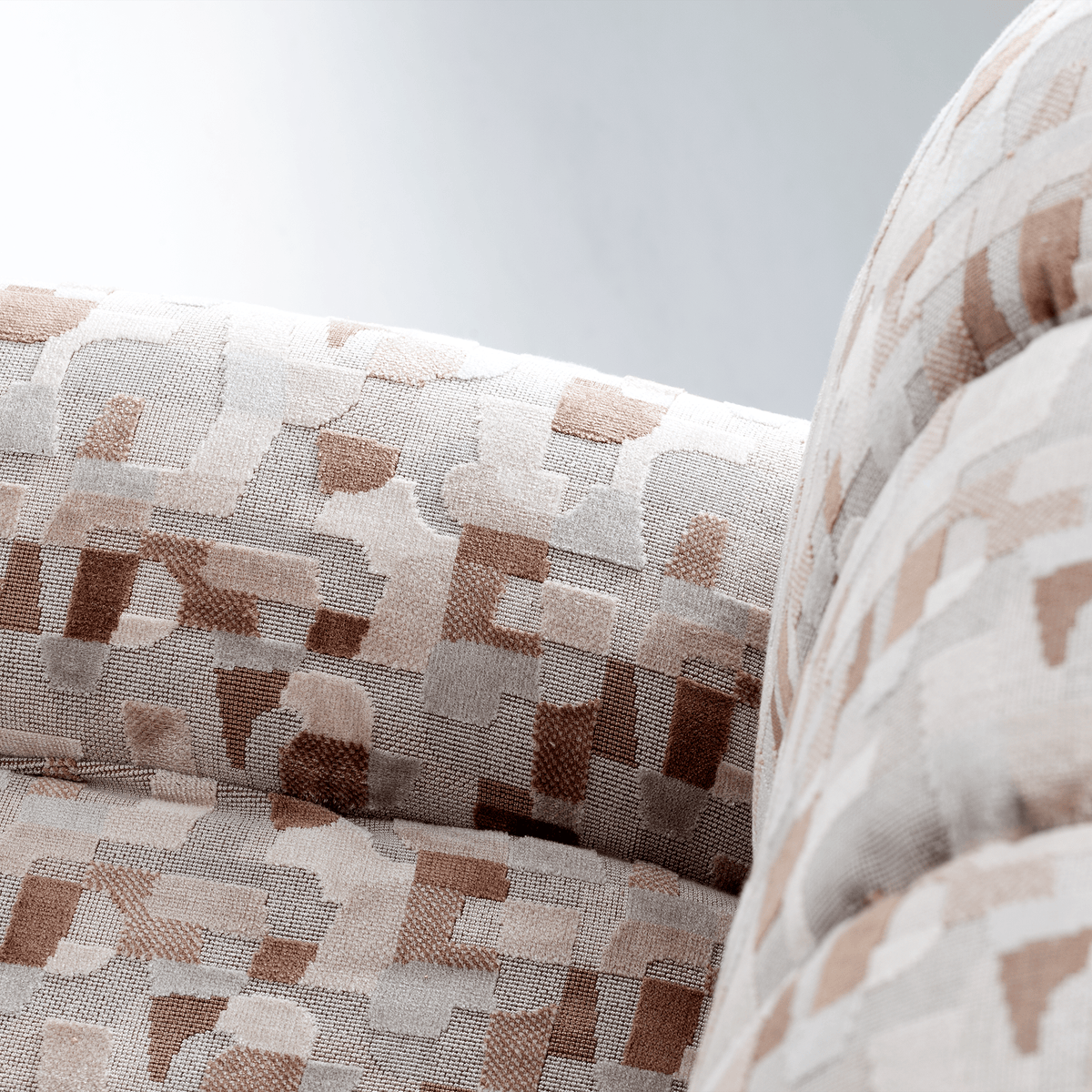 Colin Armchair close-up of channel-tufted cushions in pink and brown geometric jacquard