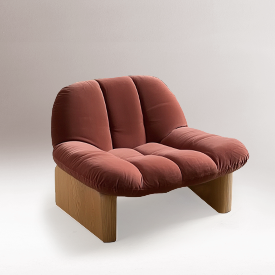 Colin Armchair in terracotta velvet on oak panel legs against a soft grey backdrop