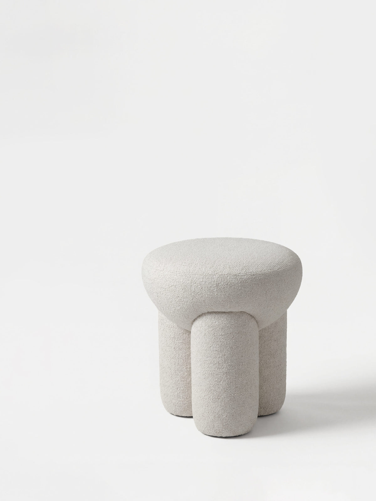 Douglas Ottoman in cream bouclé, three-quarter view
