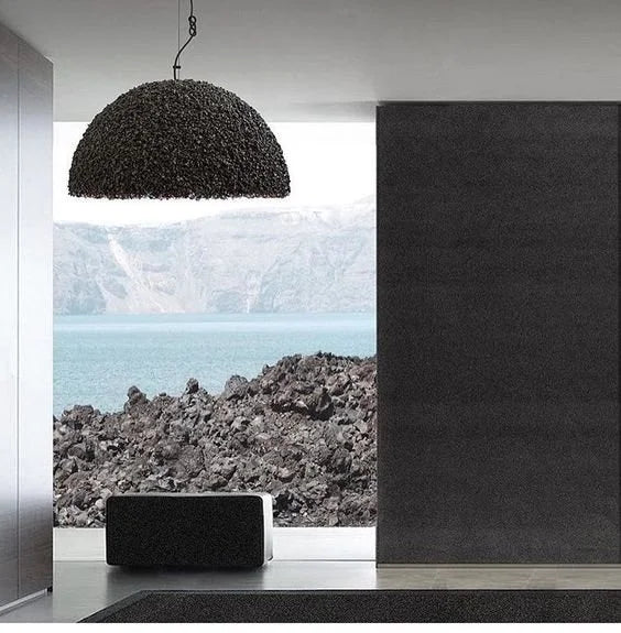 Mammalampa Duchess Pendant Light Black - Medium hanging in a minimal room with a lava-rock view