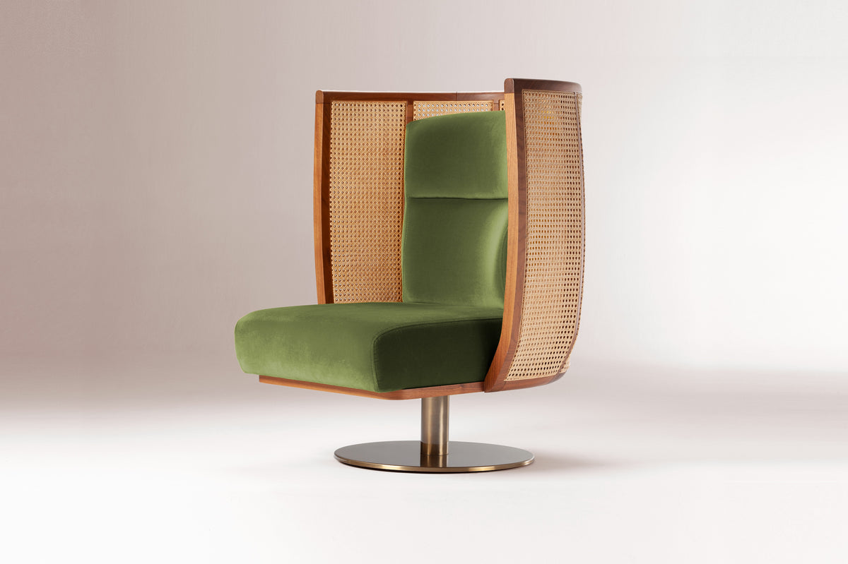 Egoista Armchair in green velvet on a soft grey backdrop