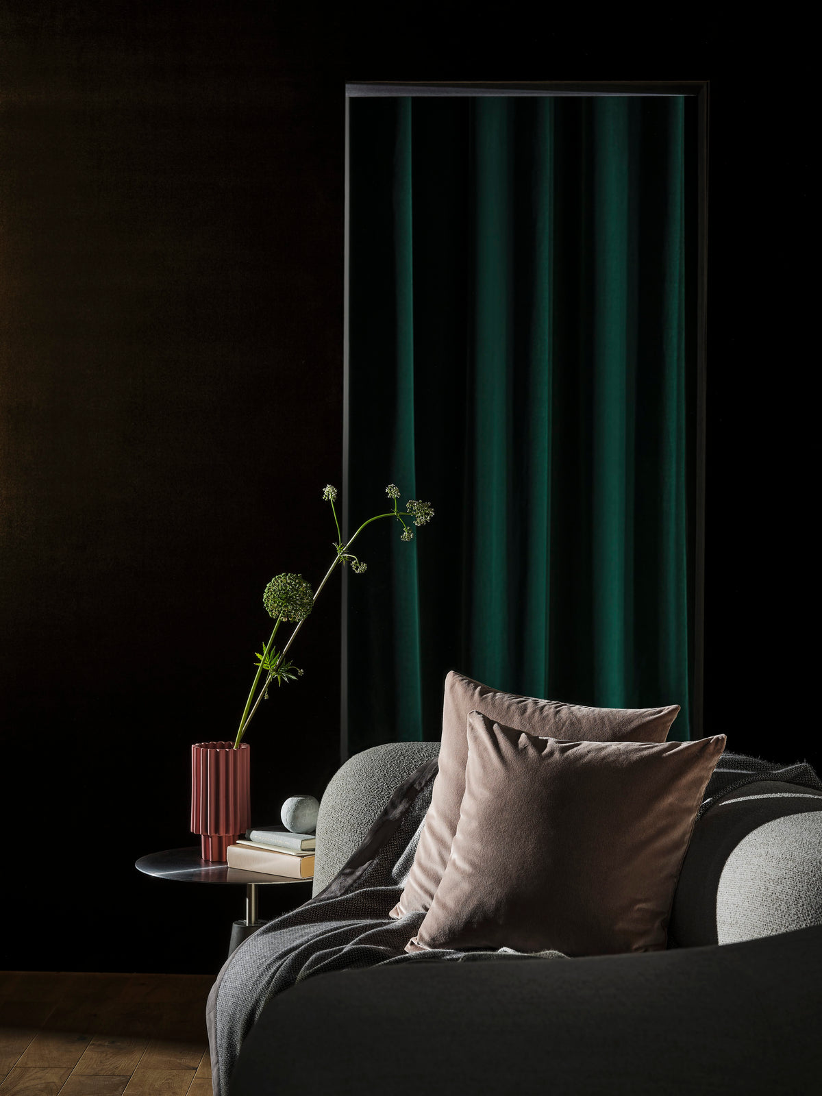 Tateyama Cloud Sofa in a dark room with green curtain and blush pillows