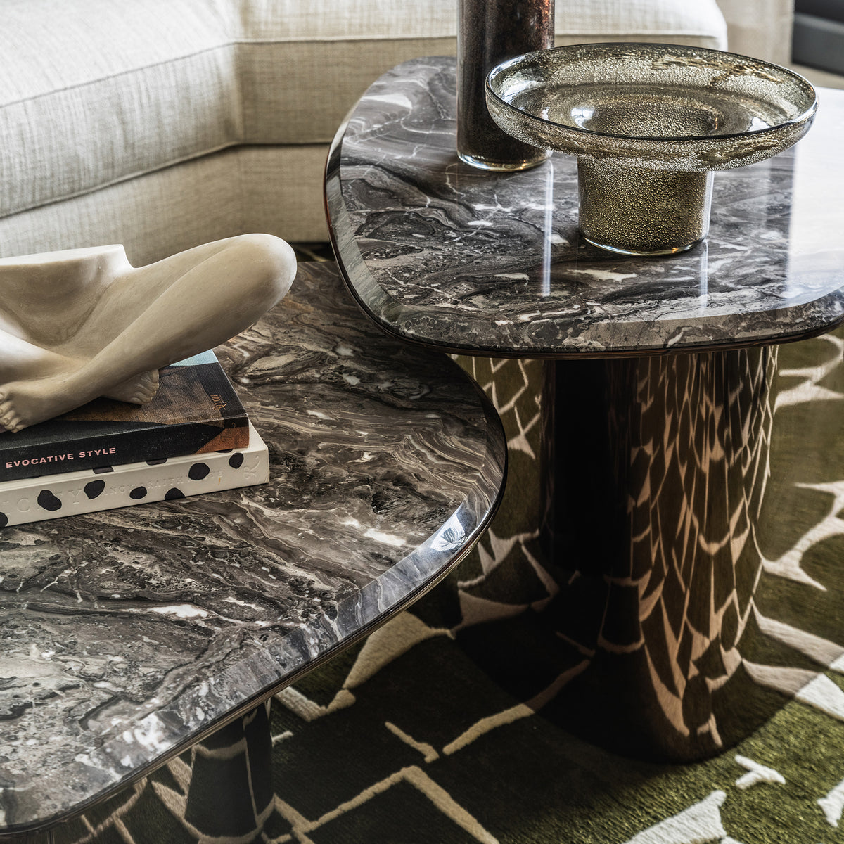 Fragment Coffee Tables in grey veined marble on a patterned rug, close-up