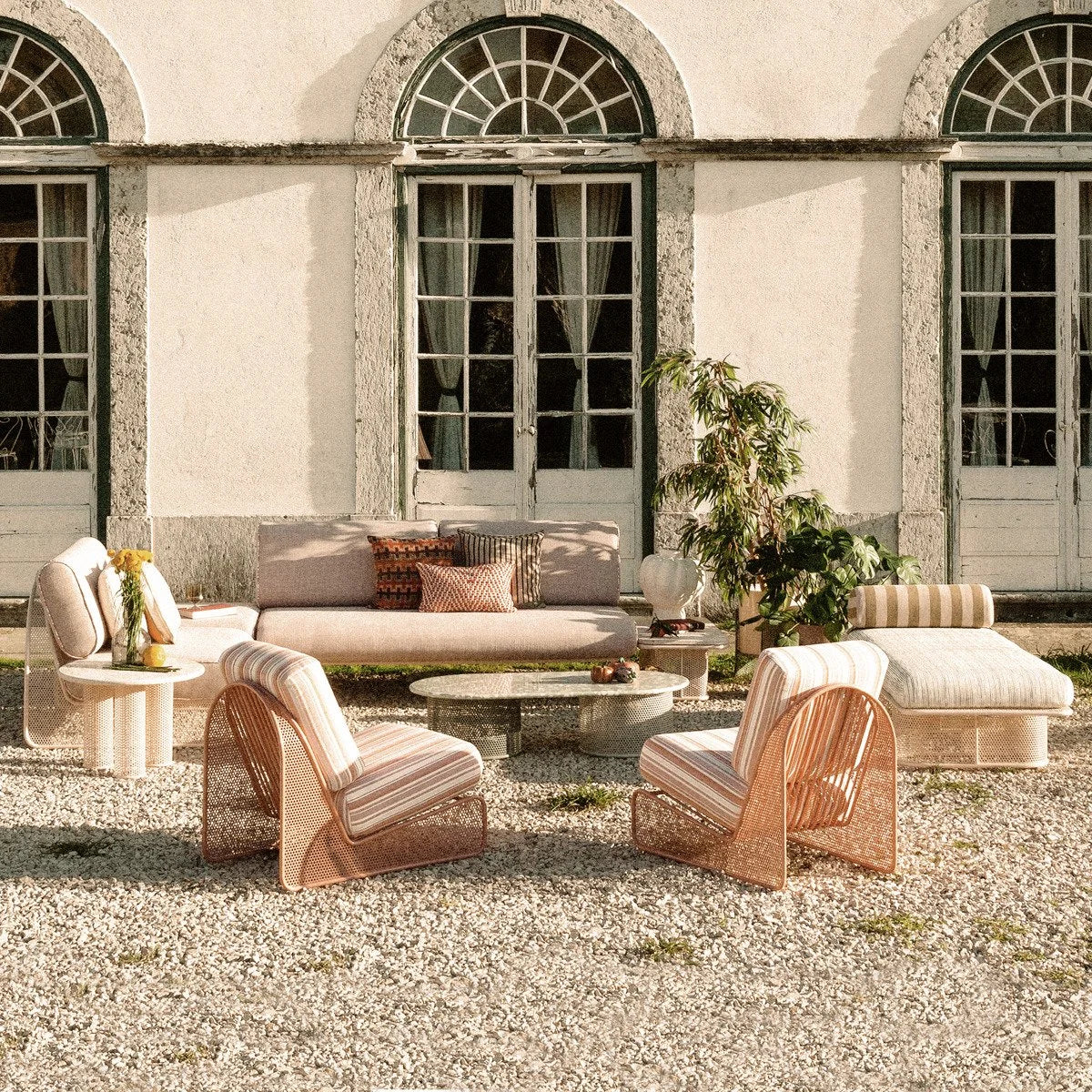 Riviera Modular Sofa Pouf with outdoor set on a gravel terrace