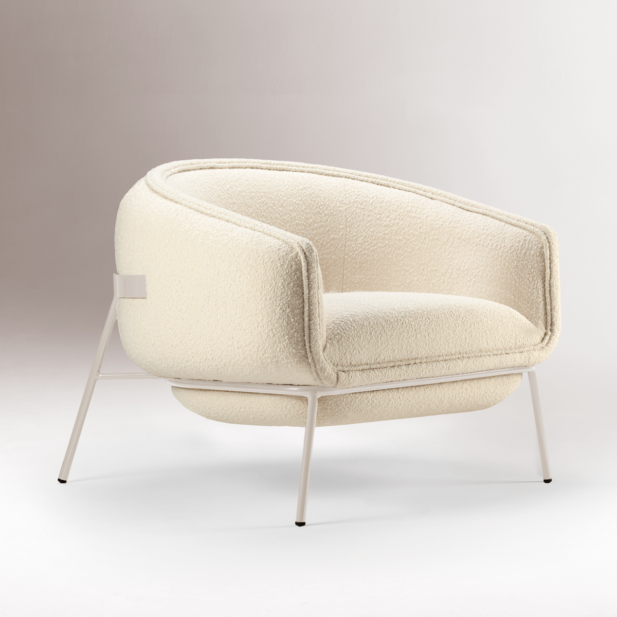 Blop Armchair in cream bouclé, three-quarter side view on grey backdrop