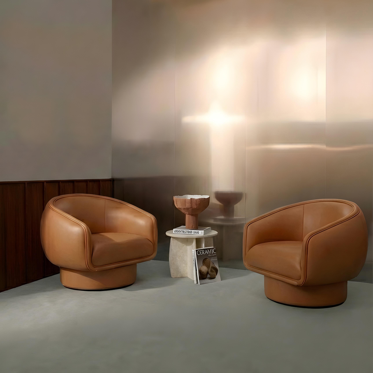 Moon Swivel Armchair pair in tan leather in a softly lit room