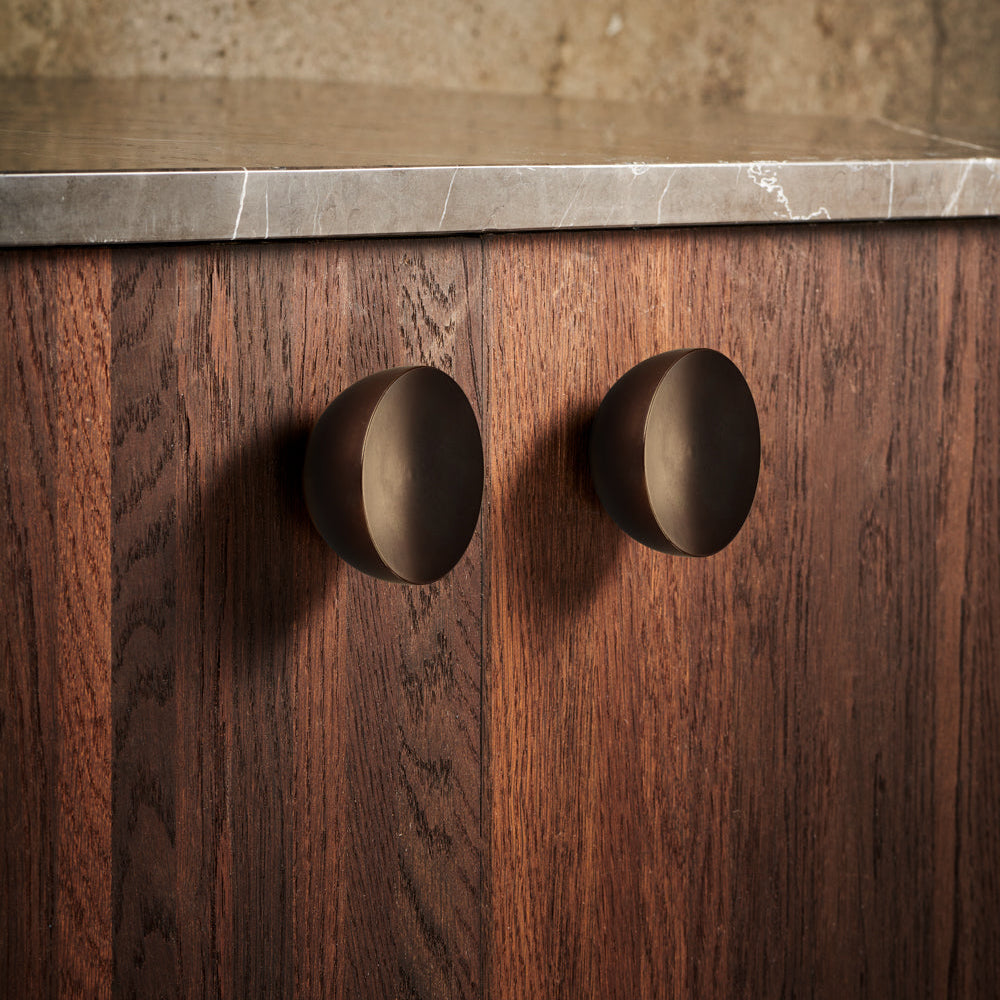 Get a Grip Cabinet Knob pair in dark browned brass on walnut cabinet doors