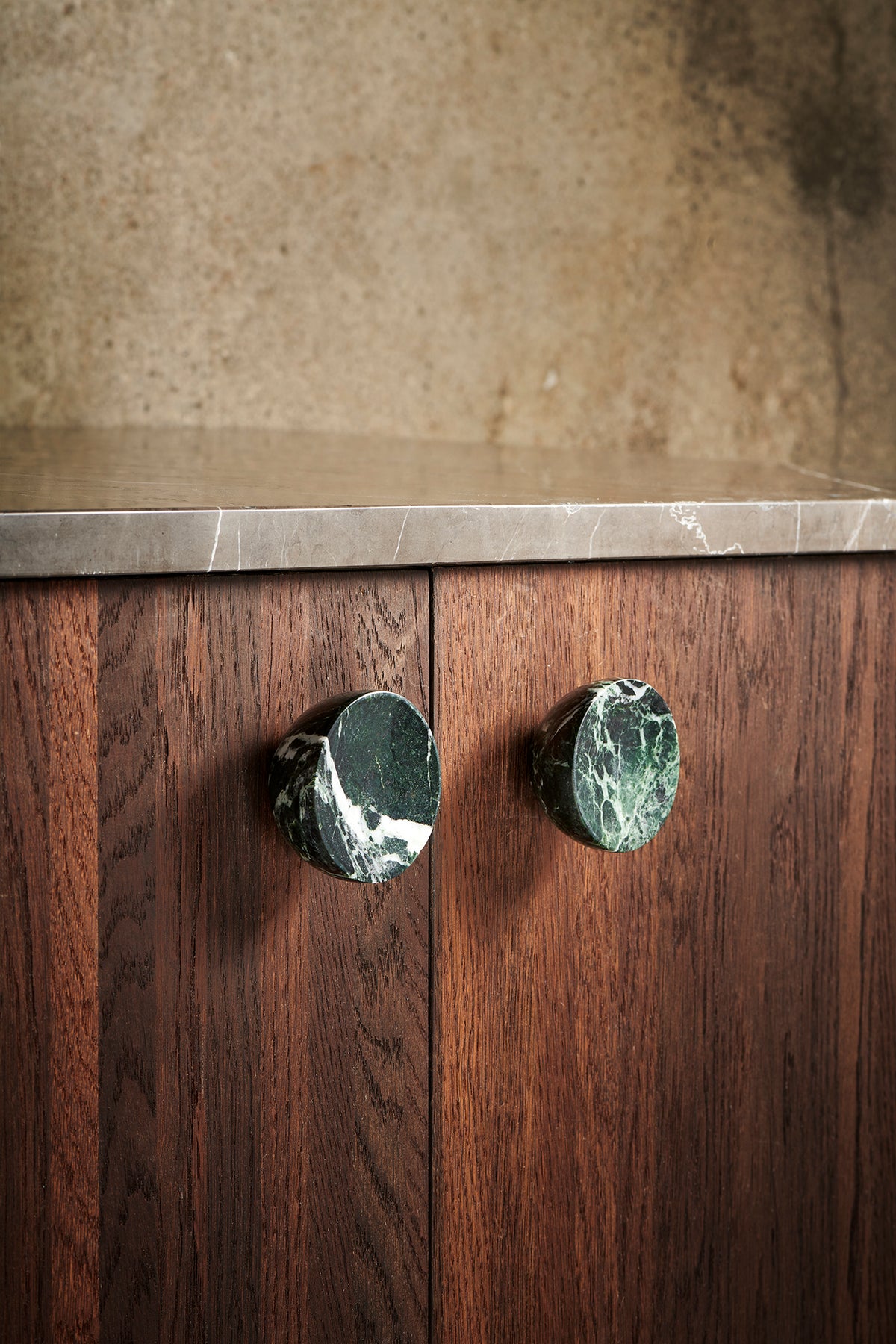 Get a Grip cabinet knobs in green marble on a walnut cabinet by Maison Burgos