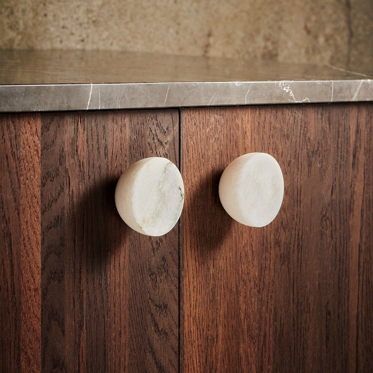 Get a Grip Cabinet Knob pair in White Marble on walnut cabinet doors