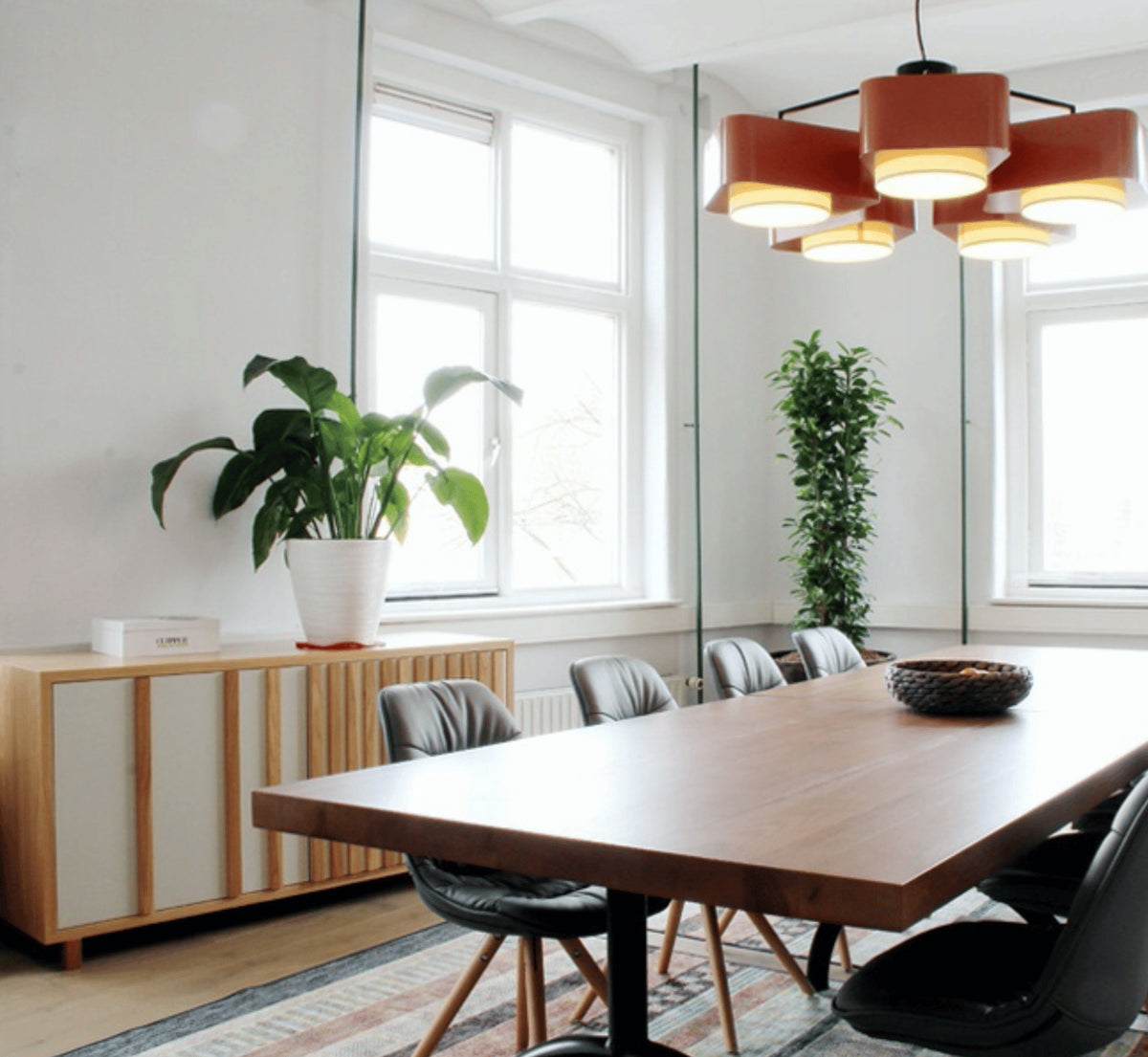 Go Sideboard in a bright dining room with a long wood table and black chairs