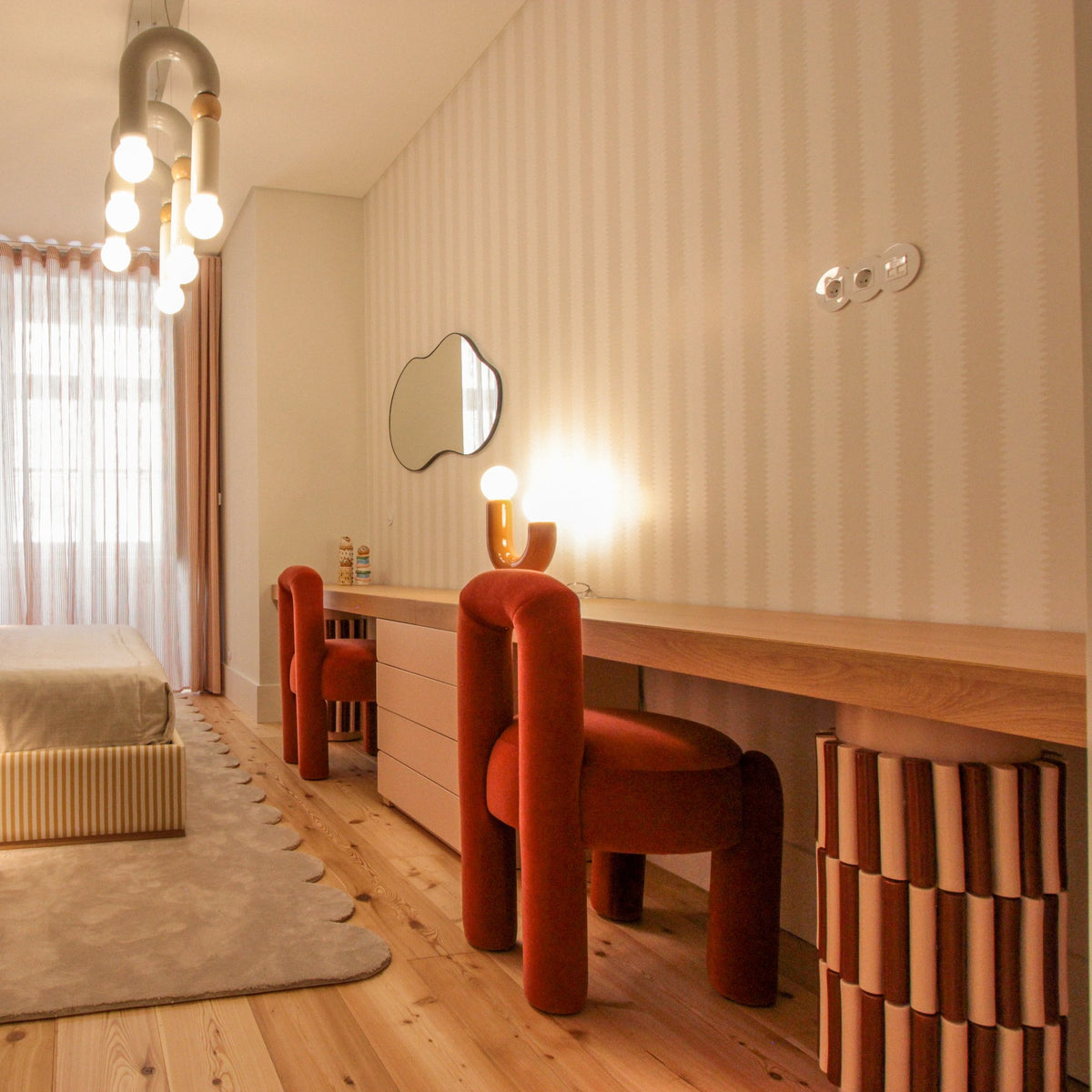 Marlon Chair in rust velvet at a long vanity desk in a striped bedroom