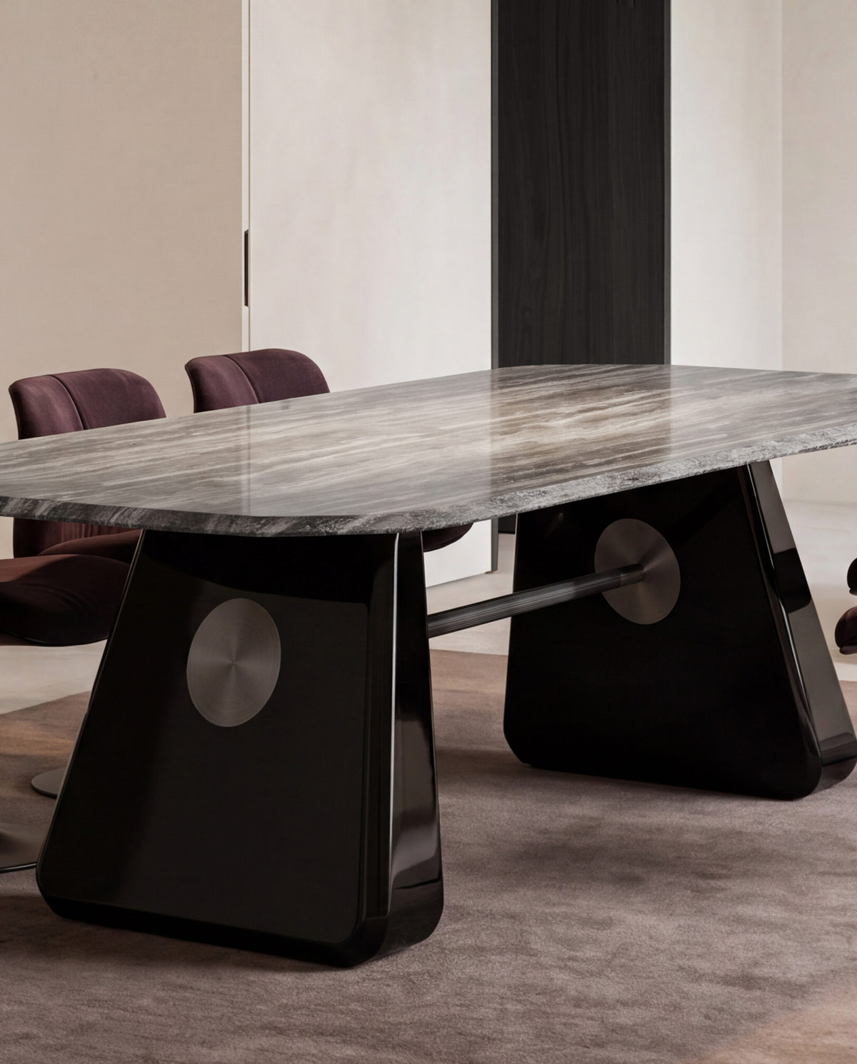 Inge Marble Dining Table close view of the glossy black leg and metal disc in a dining room