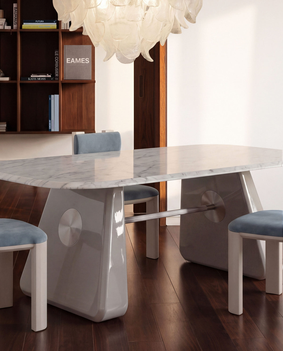 Inge Marble Dining Table in white with blue upholstered chairs under a glass chandelier