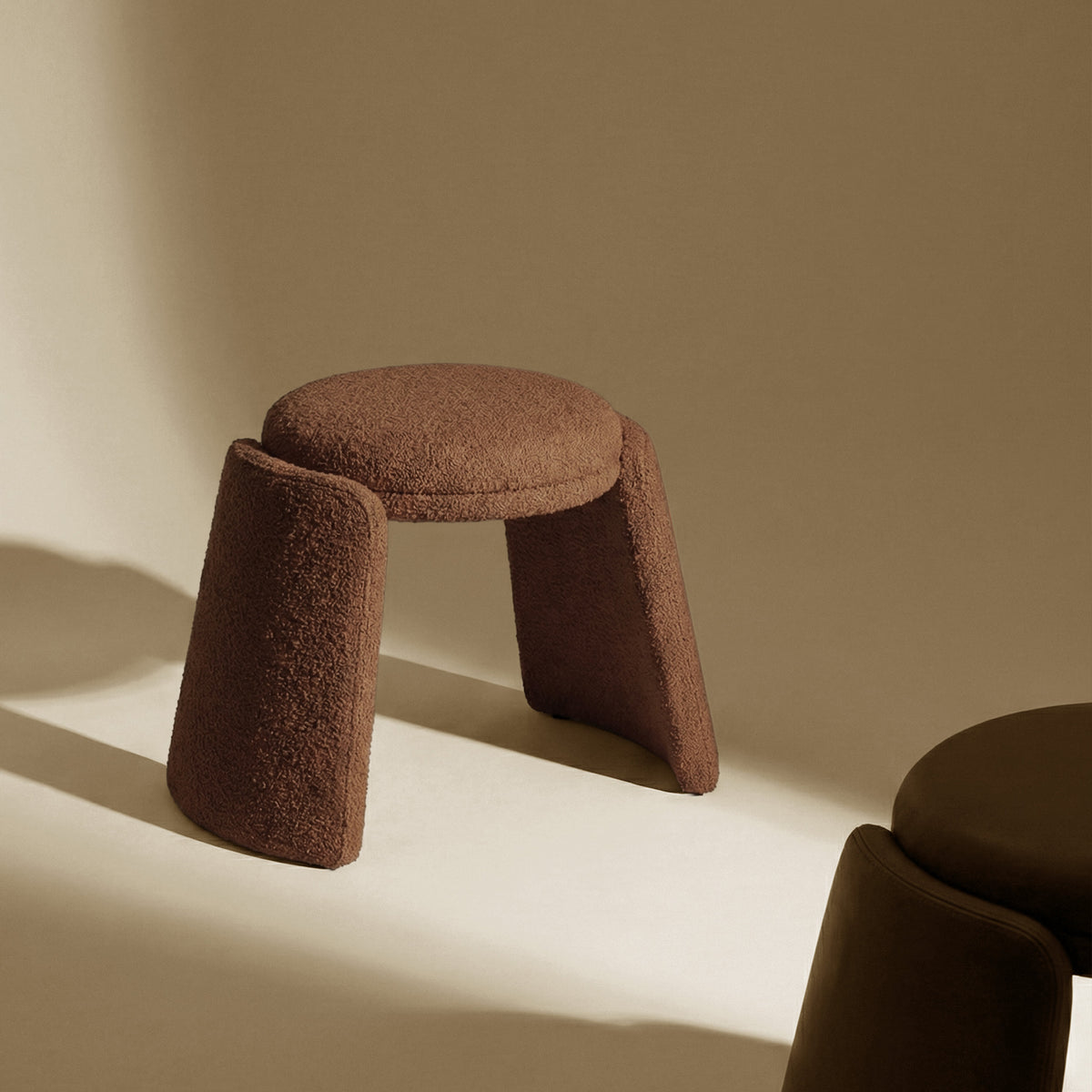 Inge Pouf in brown bouclé, close three-quarter view