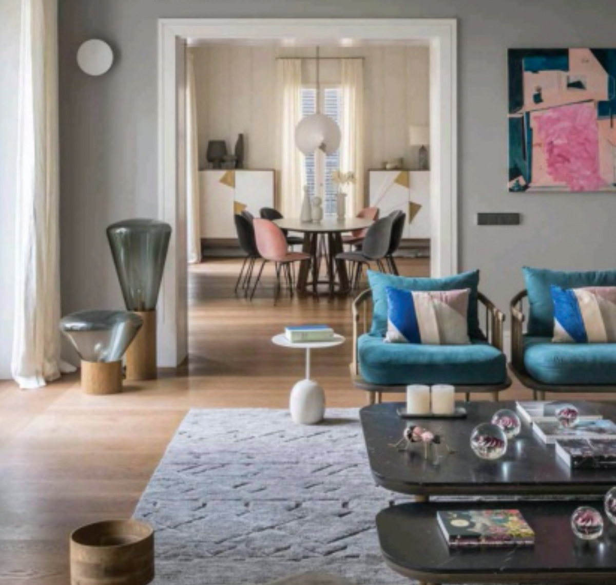 Jazz Bar Cabinet pair seen through a doorway beyond a living room with teal armchairs