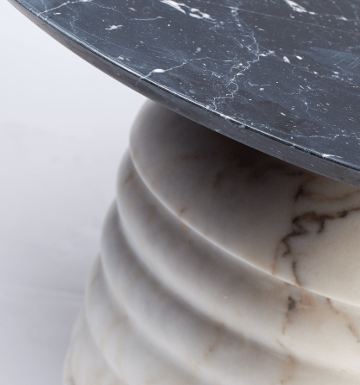 Jean Side Table close-up of white ribbed marble base under a dark marble top