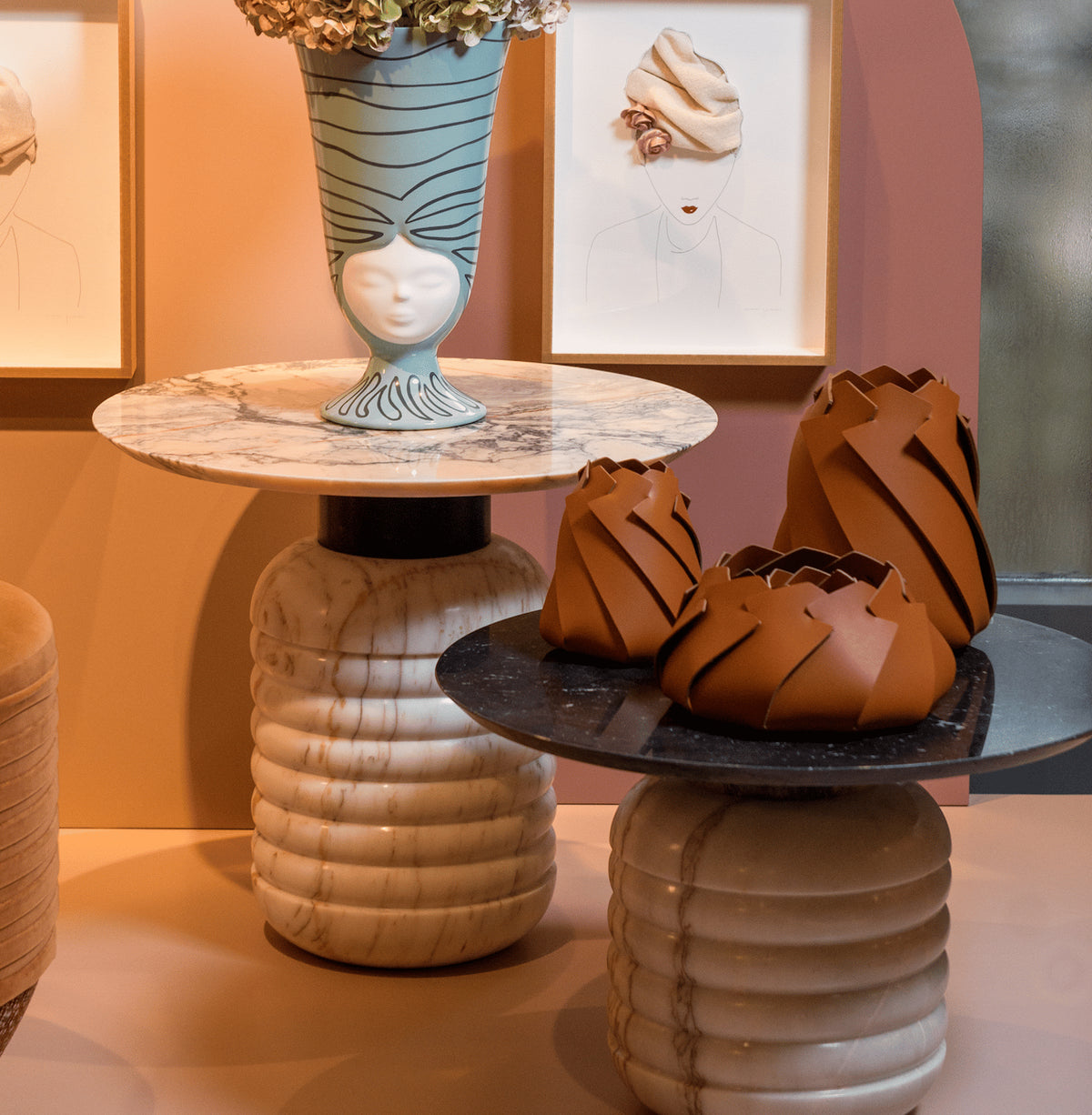 Jean Side Tables styled with a sculptural face vase and leather vessels in a peach room