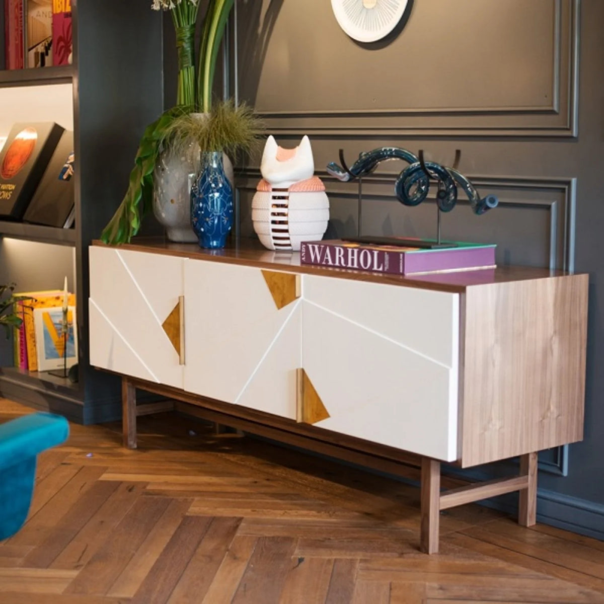 Jazz Sideboard with Ivory doors styled with books and a vase against a dark panelled wall