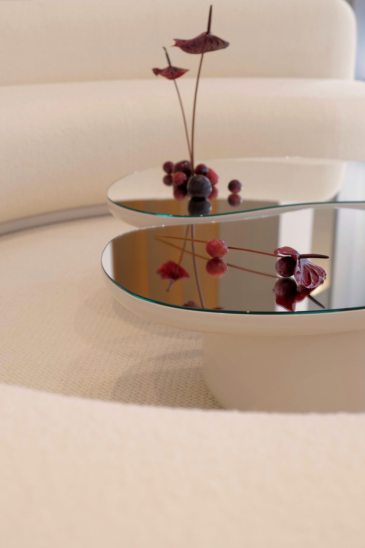 Laghi Coffee Table close-up of mirrored tops with red flower arrangement