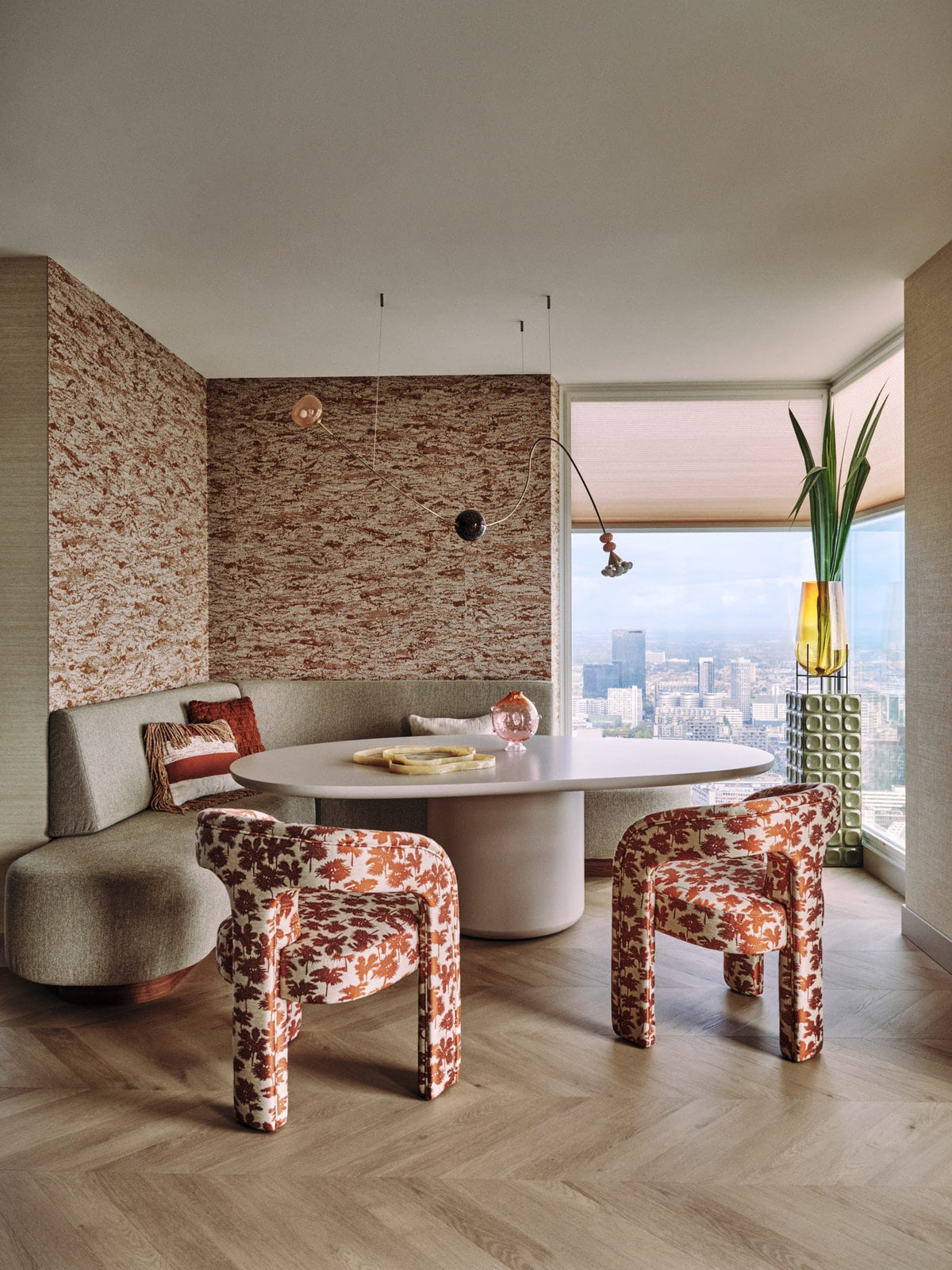 Laghi I Dining Table in white with patterned armchairs and banquette by a window