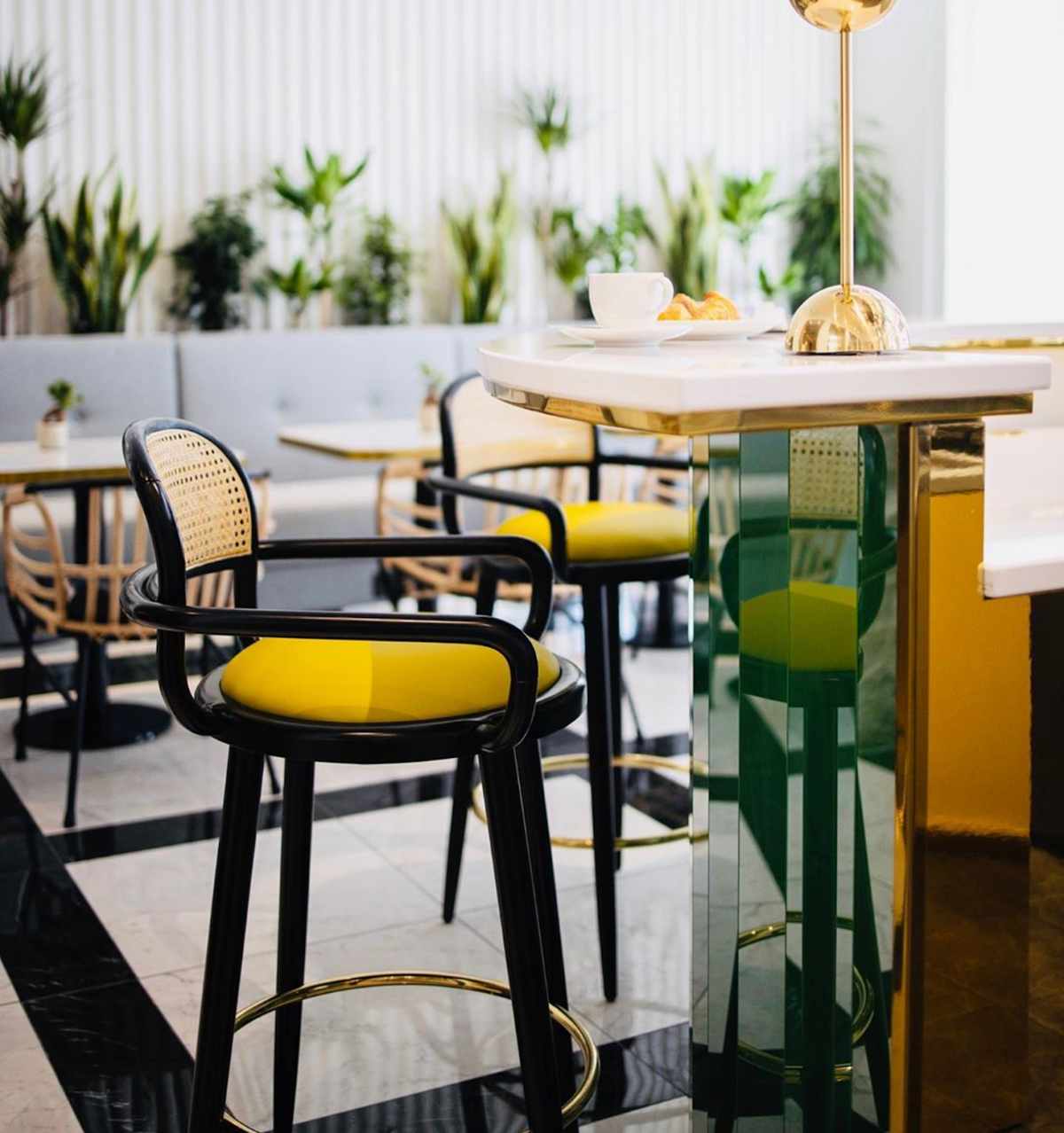 Luc bar chair with mustard seat at a marble counter