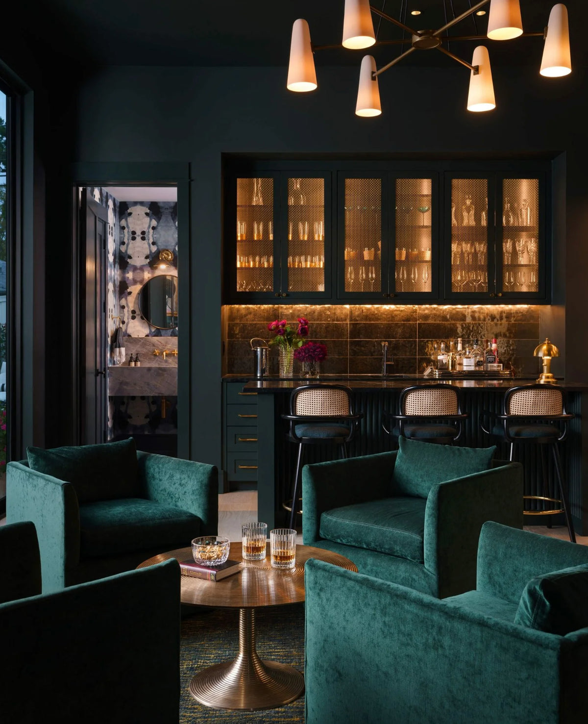 Luc bar chairs at a lounge bar with green velvet armchairs