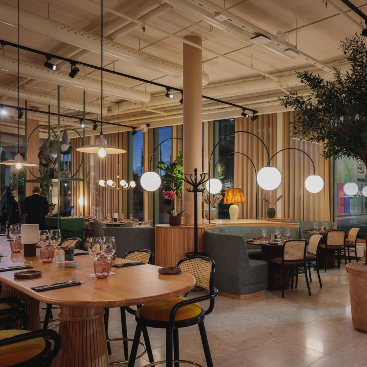 Luc rattan-back chairs in a modern restaurant dining room