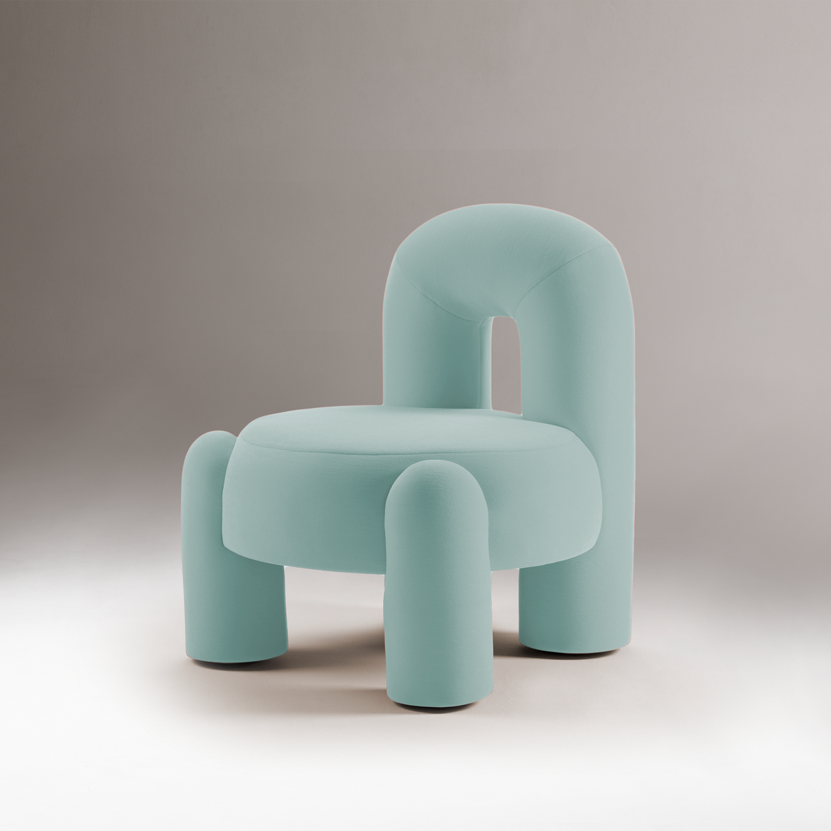 Marlon Armchair in pale aqua on a grey backdrop