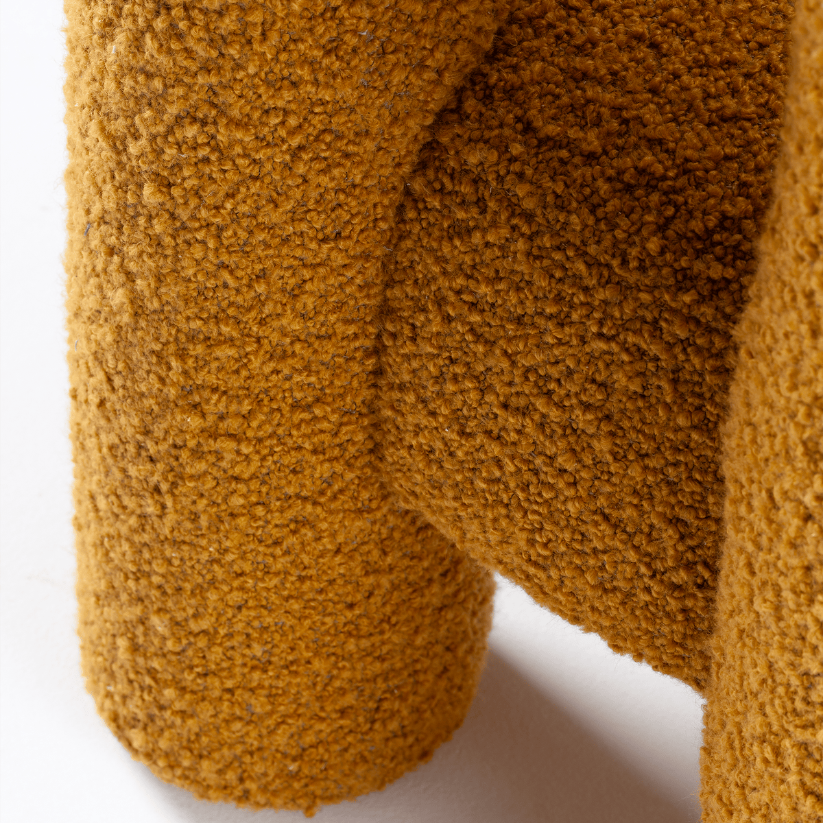 Marlon Armchair detail of mustard bouclé texture on the leg