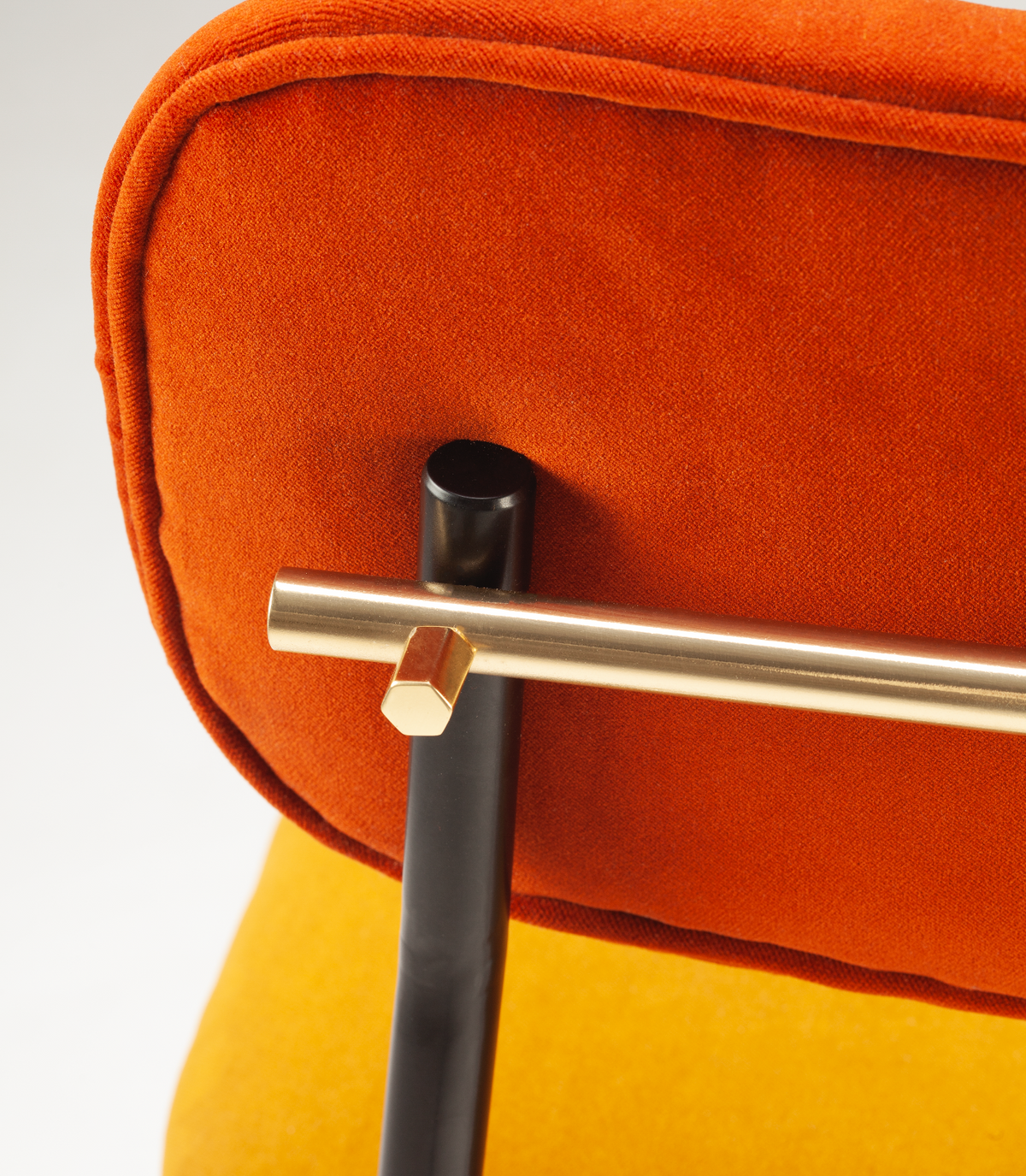 Miami Dining Chair, close-up of the orange velvet backrest and Polished Brass rail