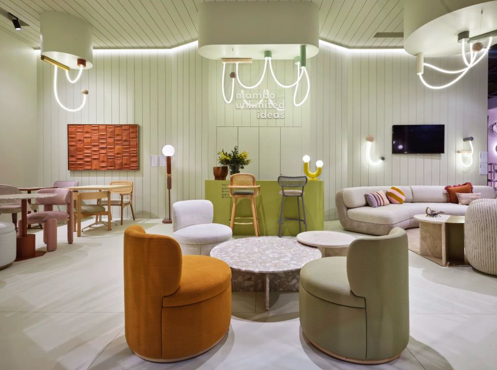 Mimi Swivel Lounge Chairs in orange and sage in a lounge with a round marble table