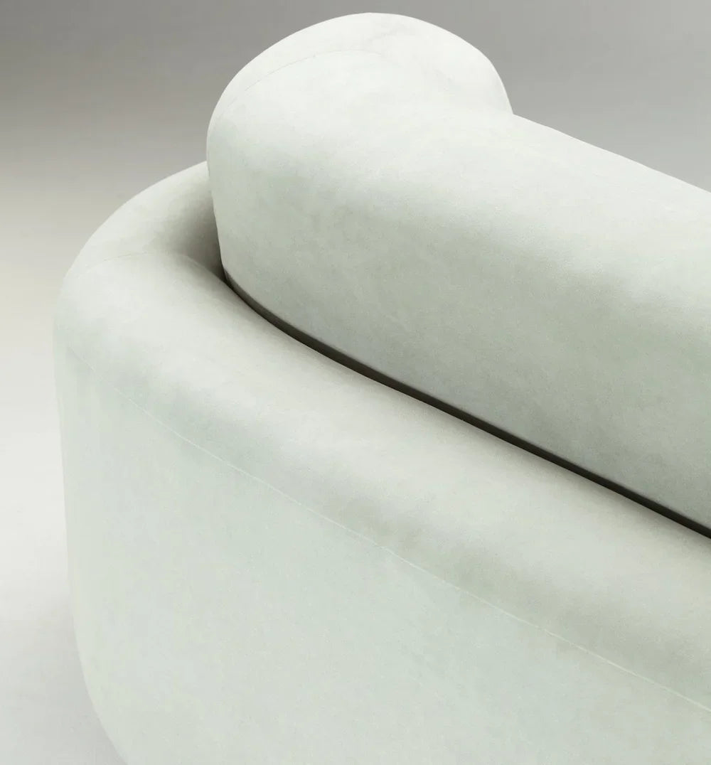 Naked Round Sofa close-up of the rounded backrest in pale sage velvet