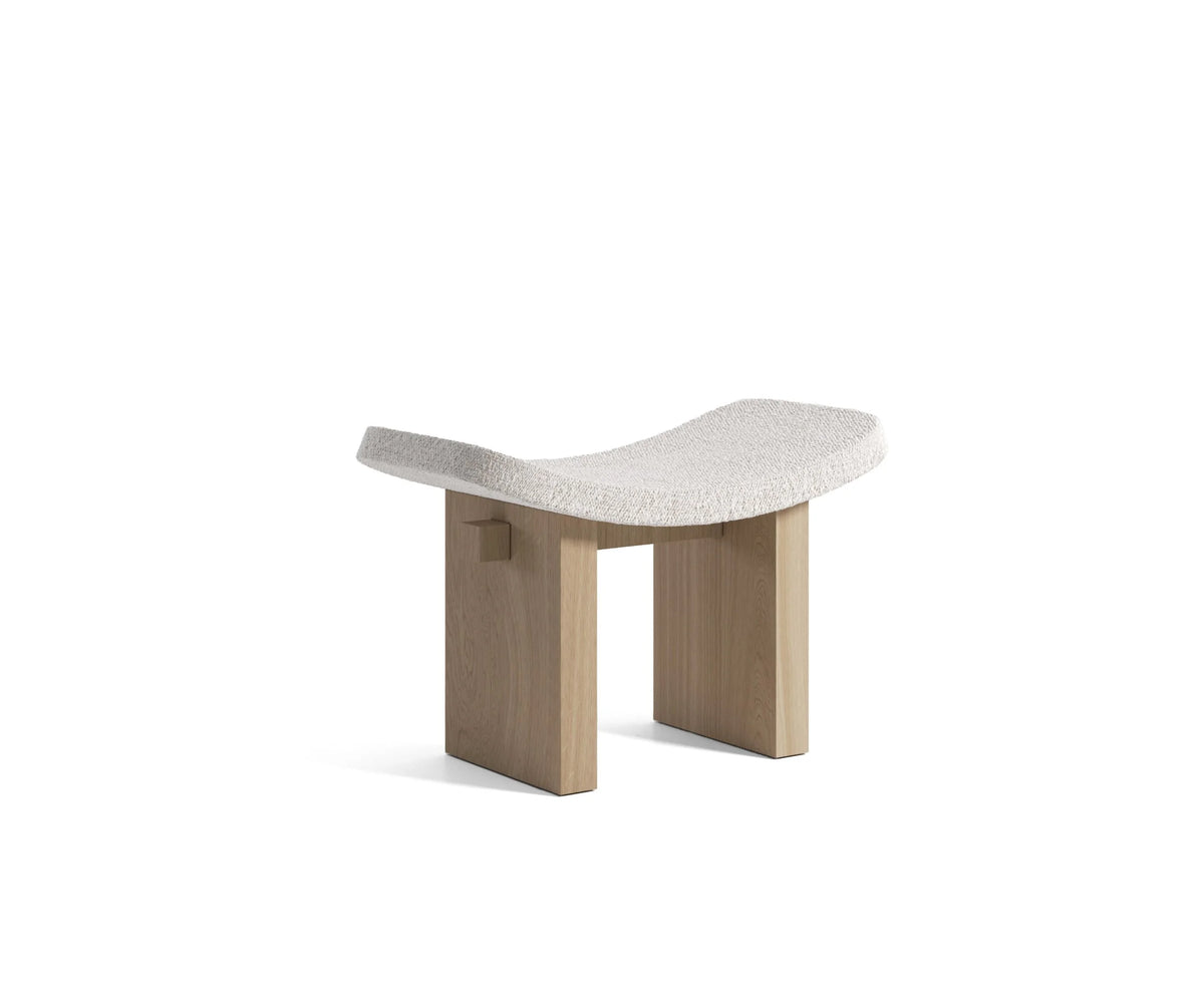 Nara Ottoman in ivory bouclé with light wood legs, three-quarter view on white
