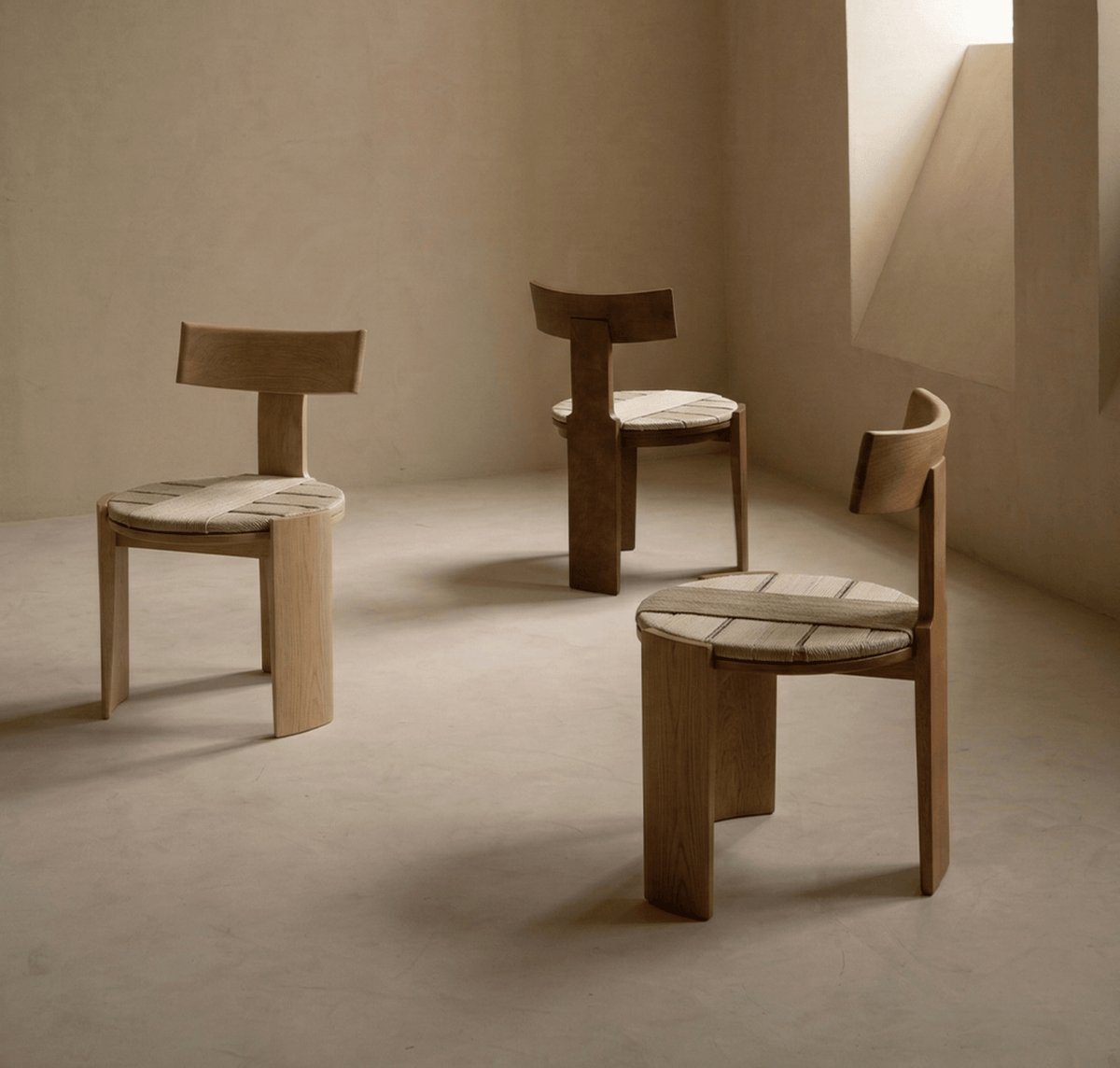 Nest Dining Chairs in light and dark ash with rush seats in a minimal beige room