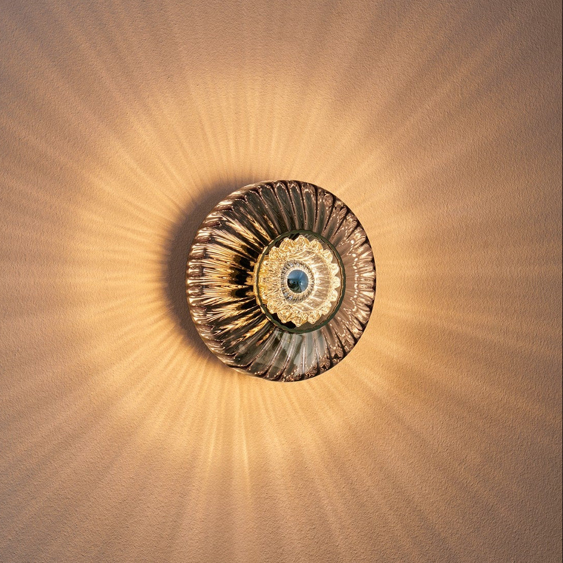 New Wave Optic Wall Light Sconce - Smoke glowing on a warm-toned wall
