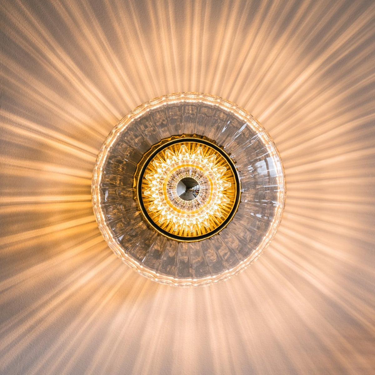 New Wave Optic Wall Sconce in Clear glass with eyeball, lit close-up front view