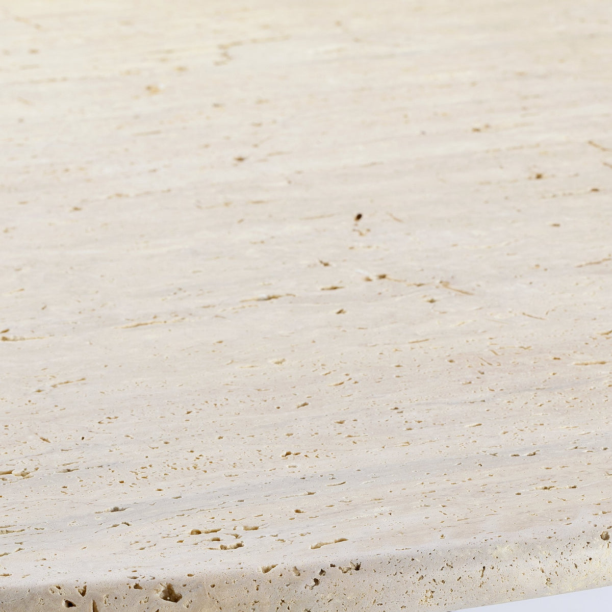 Nouvelle Vague Dining Table close-up of the Travertine top surface