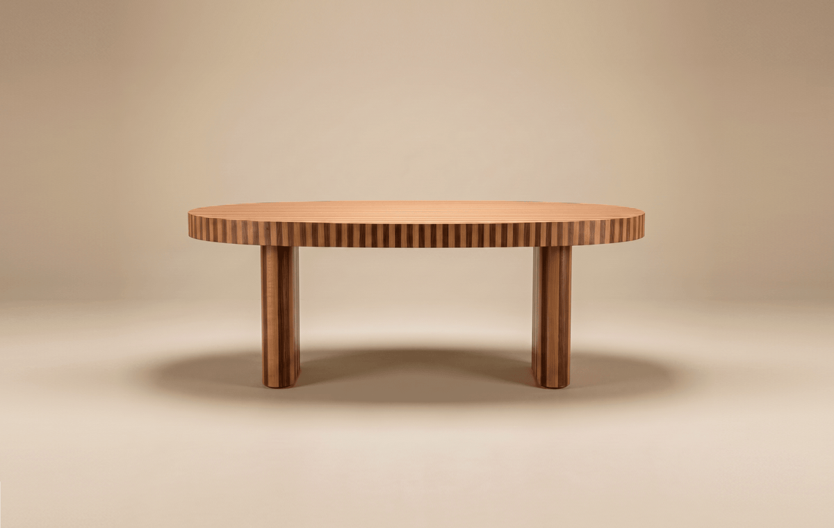 Nusa Dining Table in fluted wood on a beige backdrop