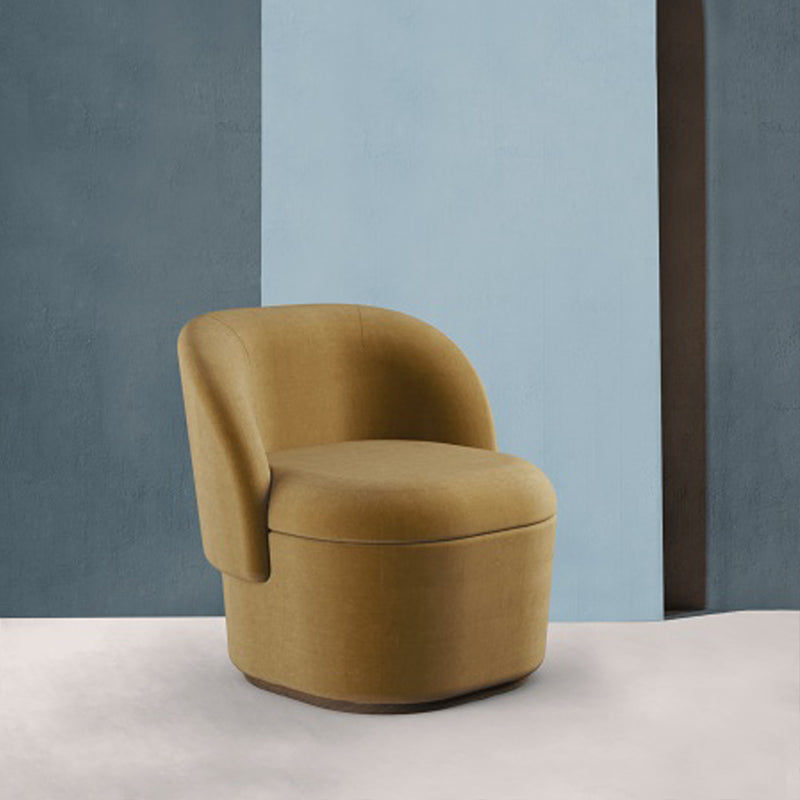 Bisou Armchair in mustard fabric against a blue and grey wall