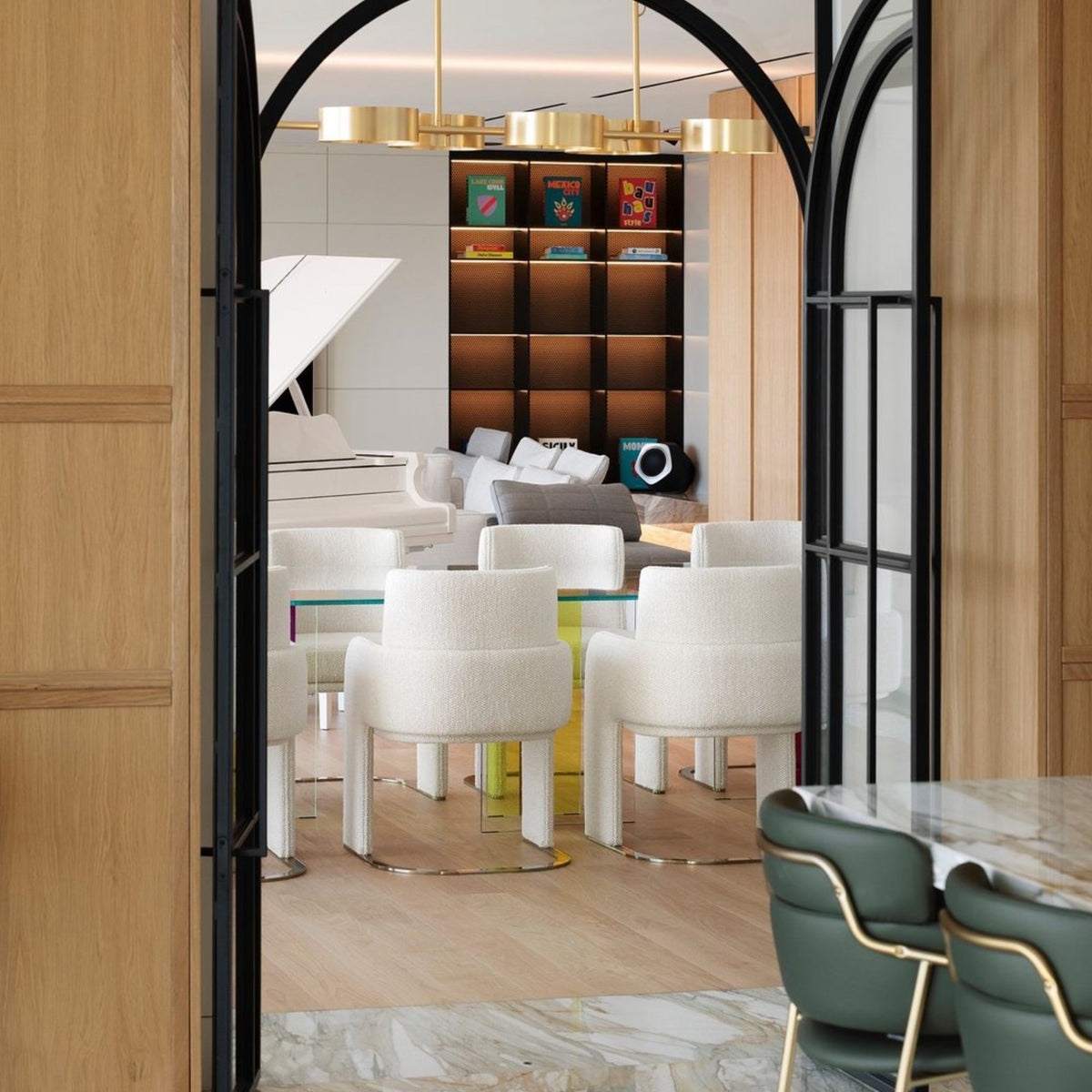 Odisseia Dining Chairs in white bouclé around a dining table seen through an arched doorway