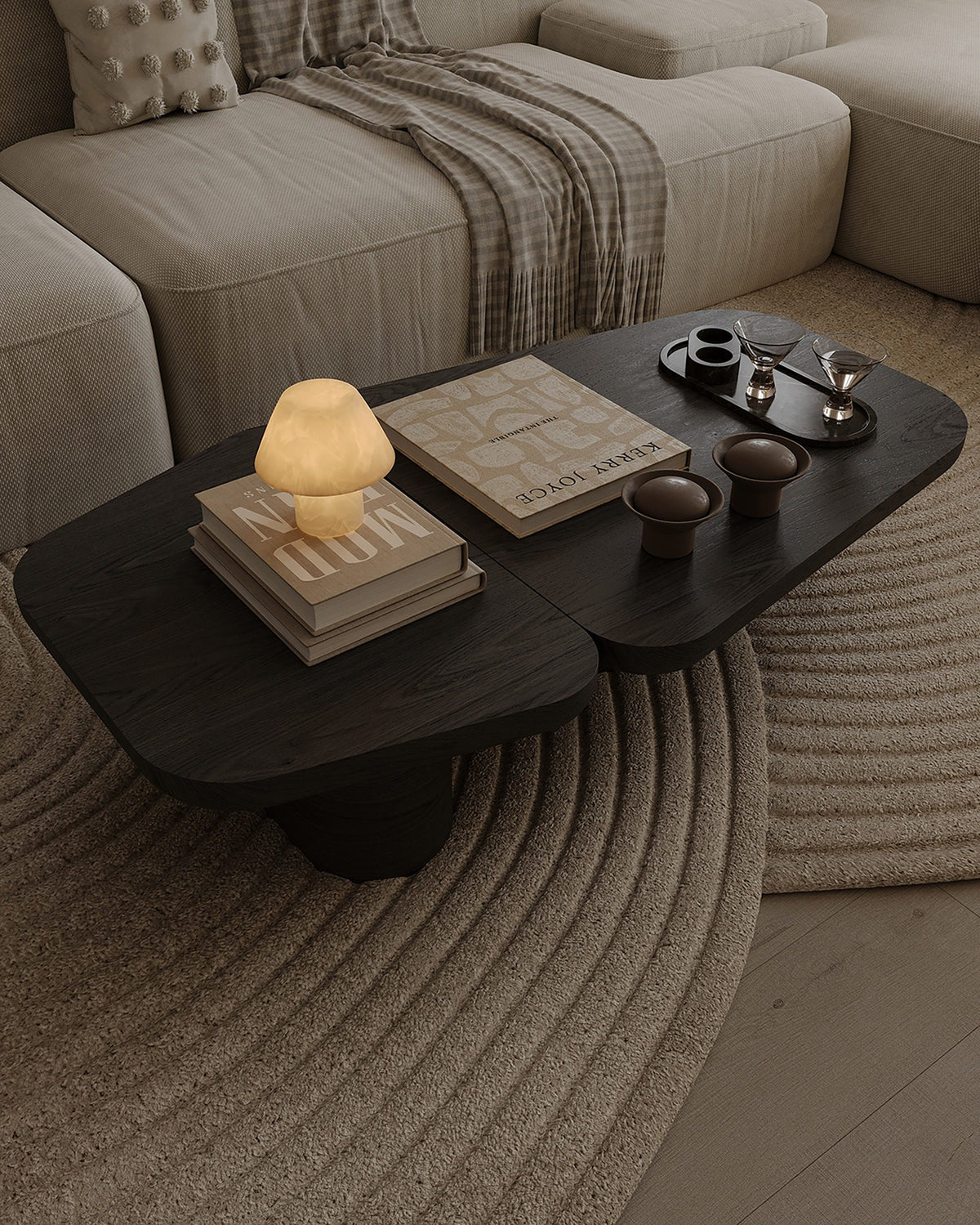 Pangea Coffee Table styled with books and a lamp on a round rug