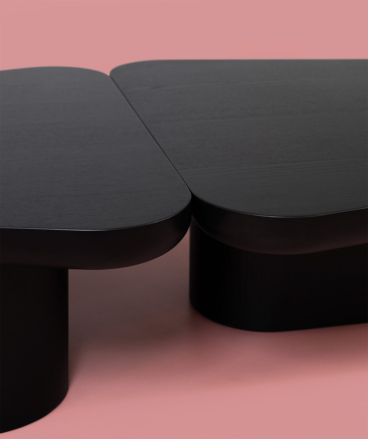Pangea Coffee Table close-up of the black top and legs on pink