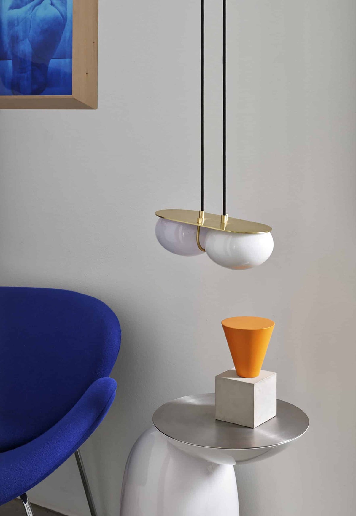 Pingu Side Table in white gloss with brushed top under a pendant light beside a blue chair