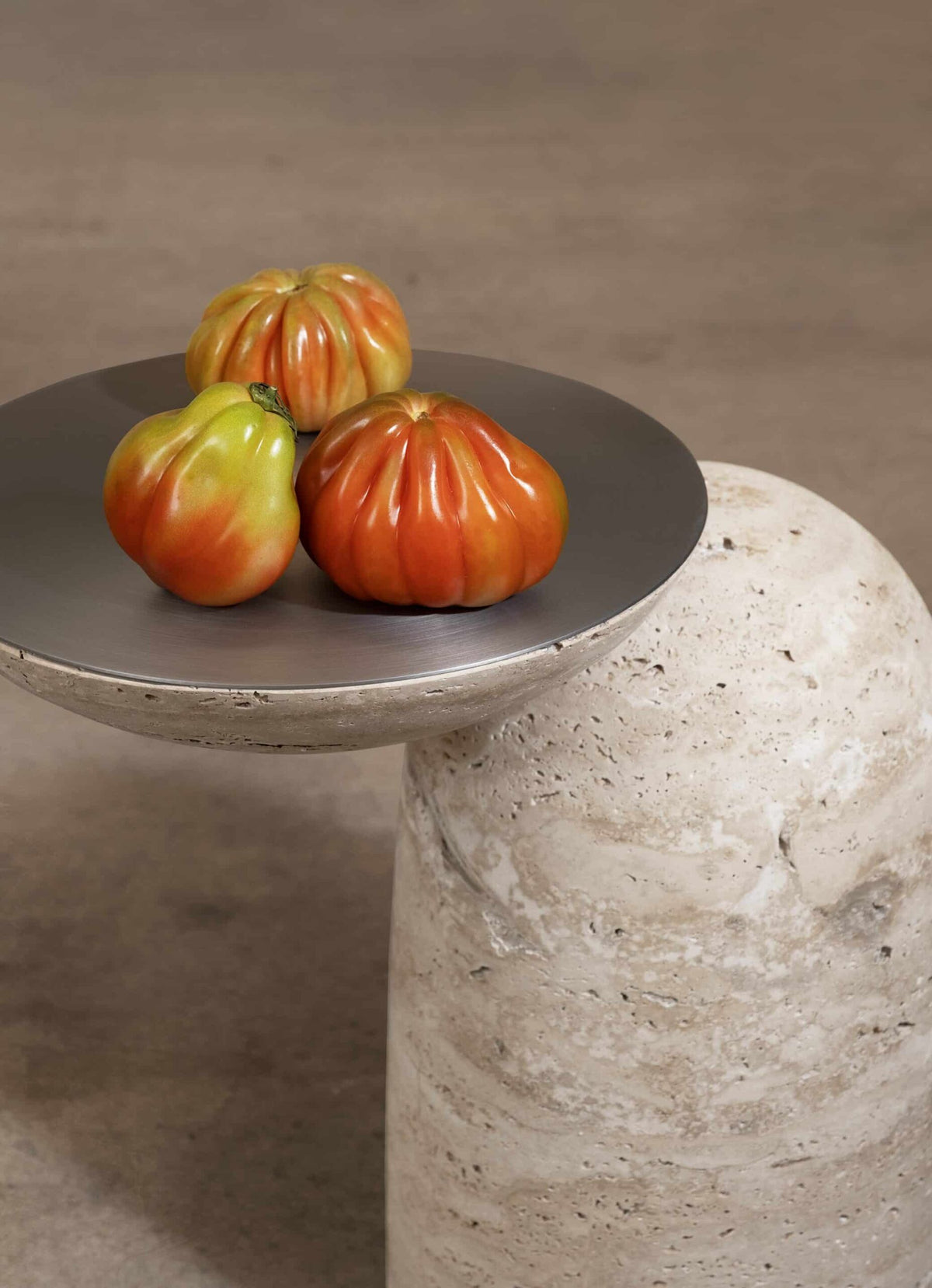Pingu X Side Table in Travertino with a metal tray top holding tomatoes