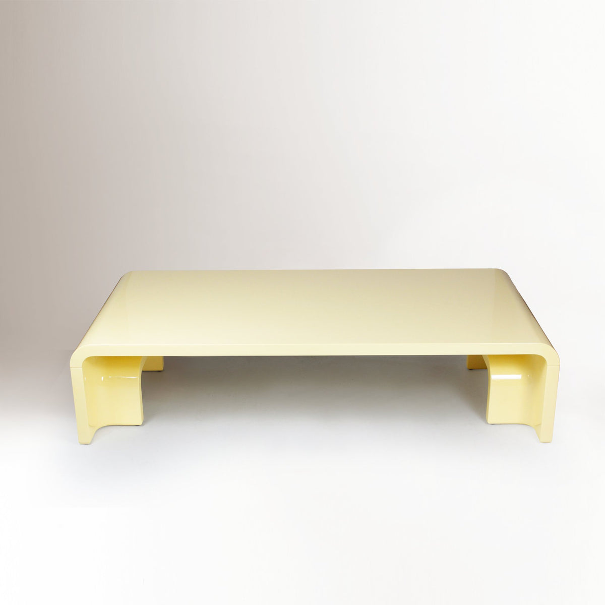 Plié Centre Table in Sand Yellow, front view showing folded waterfall legs