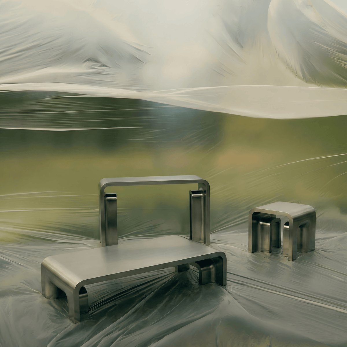Plié Console with coffee and side tables in polished steel on a translucent drape backdrop