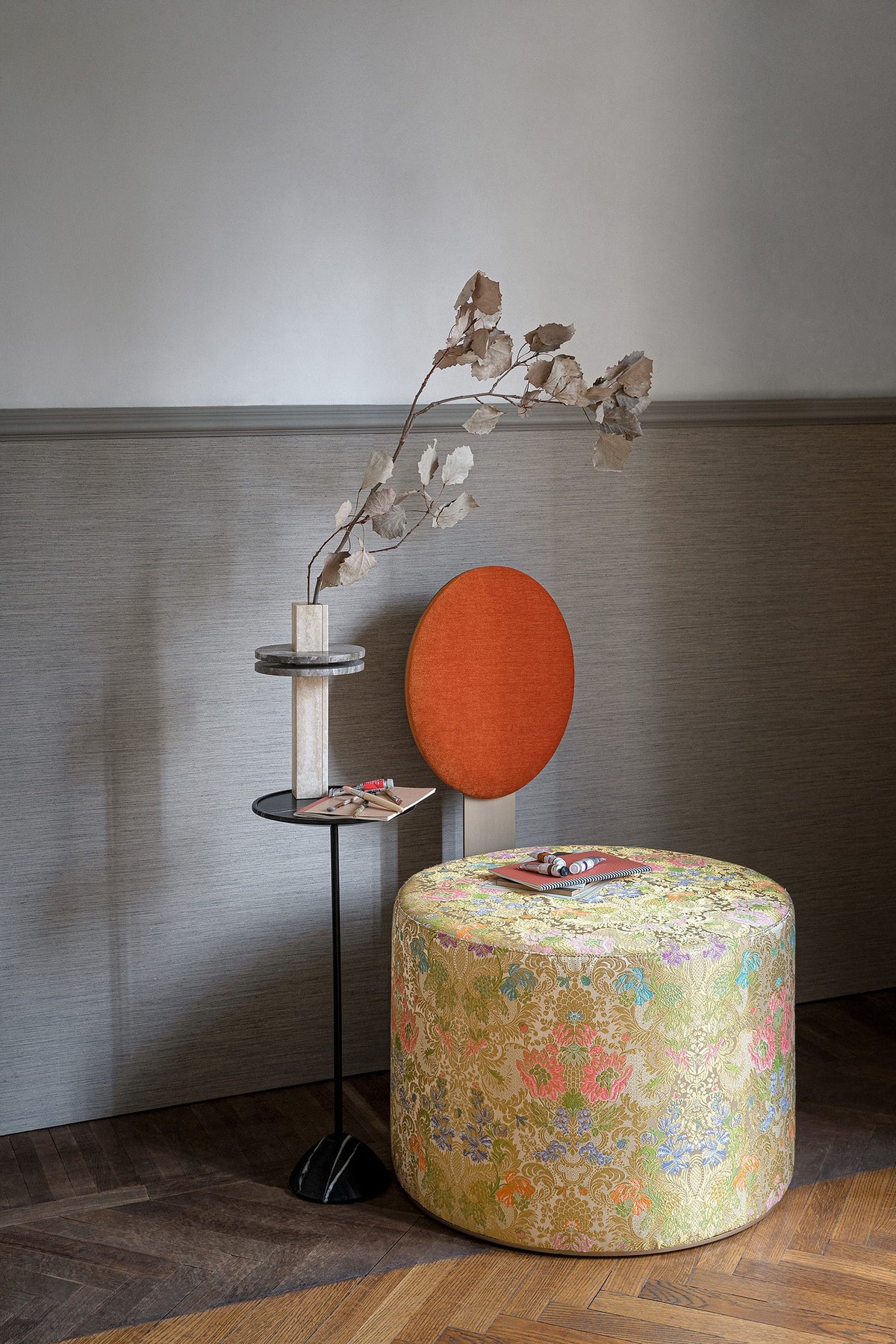 Pop Lounge Chair with orange backrest and floral seat in a living room